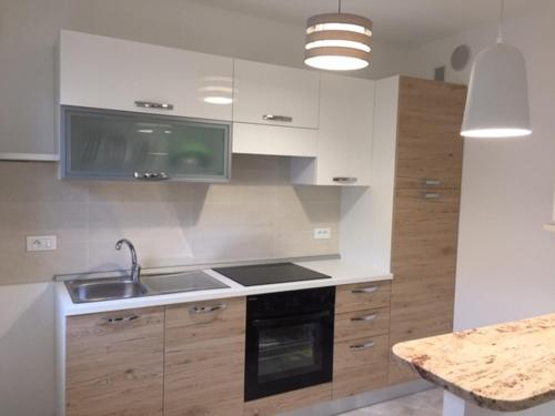 une cuisine avec un évier et une cuisinière four supérieur dans l'établissement Studio centre ville entièrement rénové au calme, à Menton