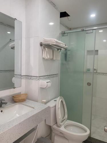 a bathroom with a toilet and a sink and a shower at Thuan Phat House Soc Trang in Soc Trang