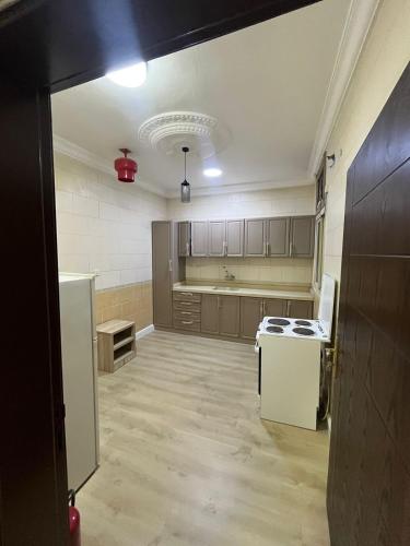 an empty kitchen with a stove and a refrigerator at Nuzhat Al Naseem Hotel in Mecca