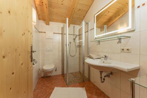 a bathroom with a sink and a shower and a toilet at Gästehaus Sieder by Schladming-Appartements in Schladming