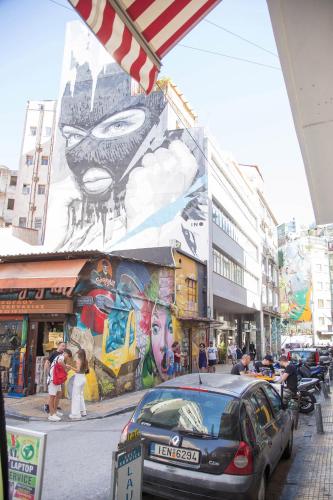 a car parked in front of a building with a mural at Mariet Athens Boutique Spa in Athens