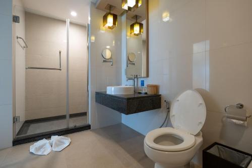 a bathroom with a toilet and a sink and a shower at Kantary Hills Hotel, Chiang Mai in Chiang Mai
