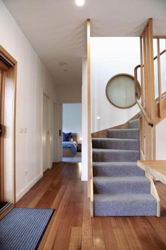a staircase in a house with a mirror at The Wooden House in Bright