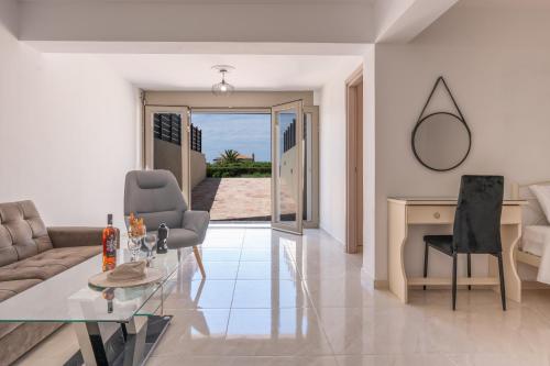 a living room with a couch and a table at Aleli Villas with Tennis Court in Minia