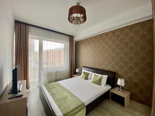 a bedroom with a bed and a tv and a window at Summerland mamaia view in Mamaia