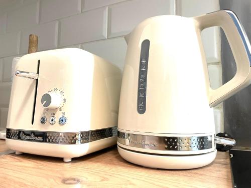 two white toasters sitting next to each other on a counter at Arina & Julien La Défense-Paris in Suresnes