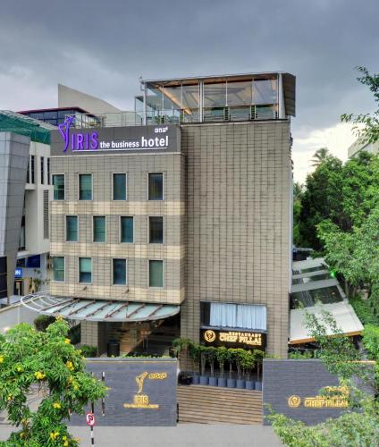 a hotel building with a sign on top of it at Iris The Business Hotel in Bengaluru