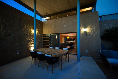 a wooden table and chairs on a patio at Conte Marino Villas in Maleme