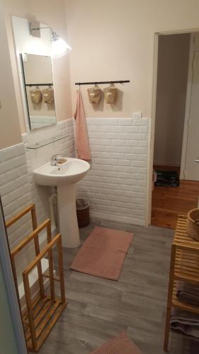 a bathroom with a sink and a mirror at Gîte de charme la belle histoire in Prades