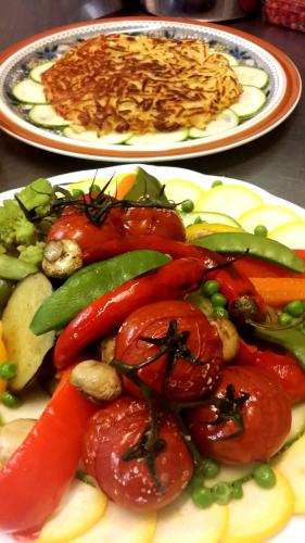 two plates of food with tomatoes and vegetables on them at Schifferkrug Hotel & Weinstube in Celle