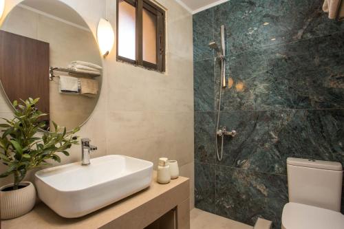 a bathroom with a sink and a shower at Casa Lyristis in Faliraki