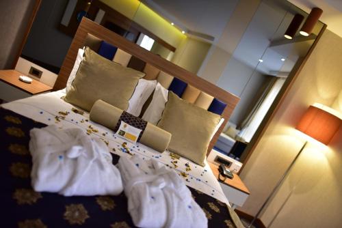 a bedroom with a bed with towels on it at Giritligil Hotel in Manisa