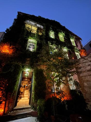 a brick building with lights on it at night at Giritligil Hotel in Manisa