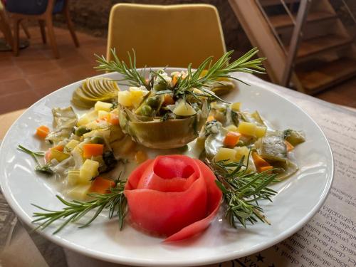 a plate of food with vegetables on a table at Giritligil Hotel in Manisa