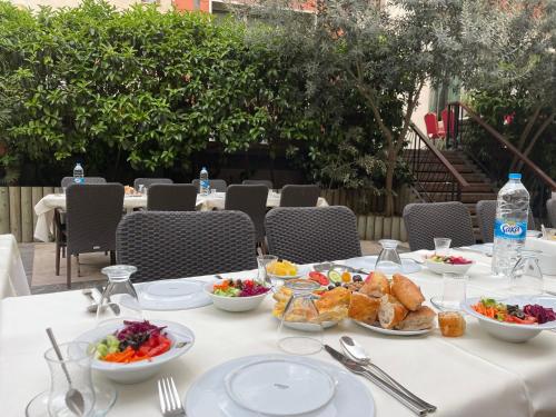 a white table with bowls of food on it at Giritligil Hotel in Manisa