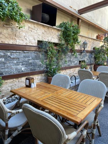 a wooden table and chairs in a patio at Giritligil Hotel in Manisa