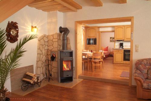 a living room with a wood stove in a room at Landhaus am Rennweg in Neuhaus am Rennweg