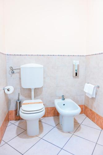 a bathroom with a toilet and a sink at Panoramic Rooms Torre della Vittoria in Ferrara