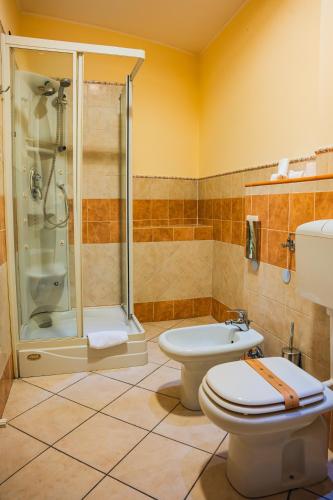 a bathroom with a shower and a toilet and a sink at Panoramic Rooms Torre della Vittoria in Ferrara