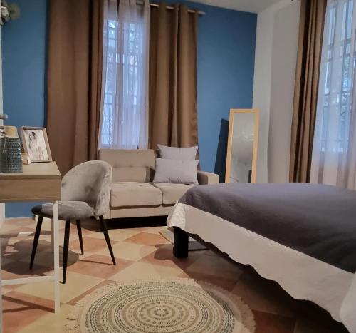 a bedroom with a bed and a chair and a desk at Cside Escape Villa in Rivière Noire