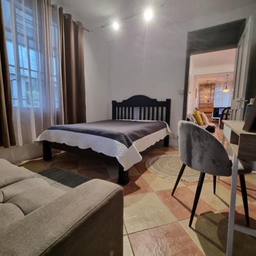 a living room with a bed and a couch at Cside Escape Villa in Rivière Noire