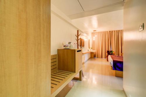 a hotel room with a bedroom and a bed at The SSK Solitaire Hotel & Banquets in Nashik