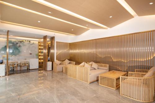 a living room with two couches and a table at Moon River View Hotel in Fenghuang