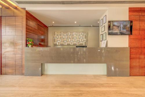 a lobby with a reception desk in a building at The SSK Solitaire Hotel & Banquets in Nashik