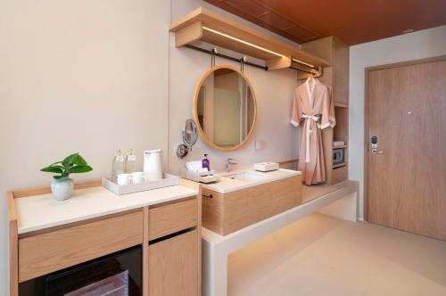 a bathroom with a sink and a mirror at Centara Ayutthaya in Phra Nakhon Si Ayutthaya