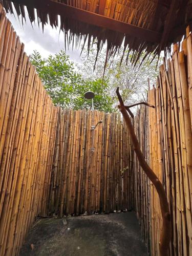 a wooden fence with a bamboo fence sidx sidx sidx at Tropical Hostel in Ko Phayam