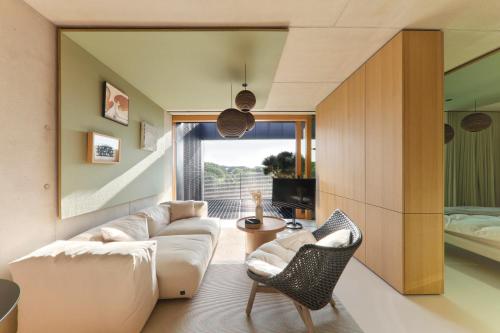 a living room with a couch and a bed at Rise - Penthouse Suite with Terrace in Luxembourg