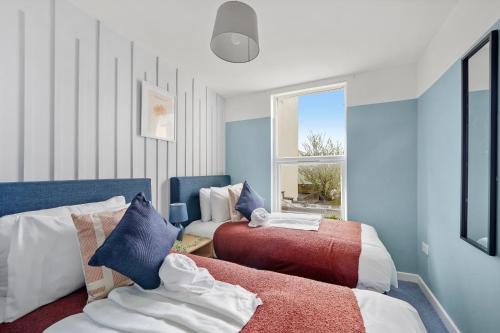 a bedroom with two beds and a window at Beautiful Boutique Apartments in Central Bristol in Bristol