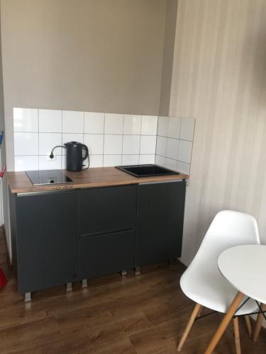 a small kitchen with a stove and a sink at Aparthotel Old Avenue in Tbilisi City