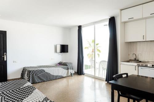 a living room with a kitchen and a dining room at Ibiza Rocks Hotel - Adults Only in San Antonio