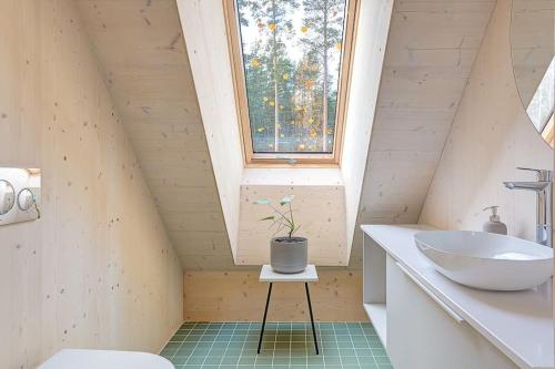 a bathroom with a sink and a window at Villa Pickala - Design - Seafront - Hot tub in Helsinki