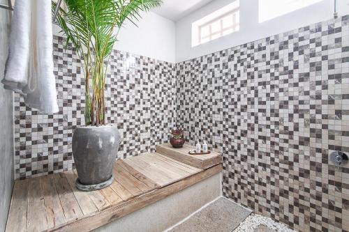a bathroom with a potted plant in a tub at Angkor Eden Boutique Hotel in Siem Reap