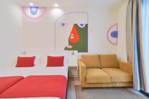 a bedroom with a bed and a chair at Blume Cruz Suites in Madrid