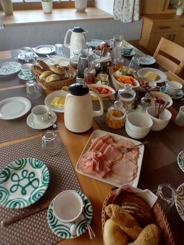 a table topped with food and plates of food at Biohof Köck Tonibauer in Zeutschach