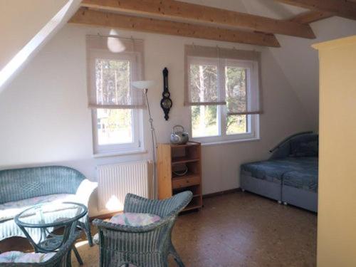 a bedroom with a bed and a table and chairs at Ferienhaus Wassermann in Trassenheide