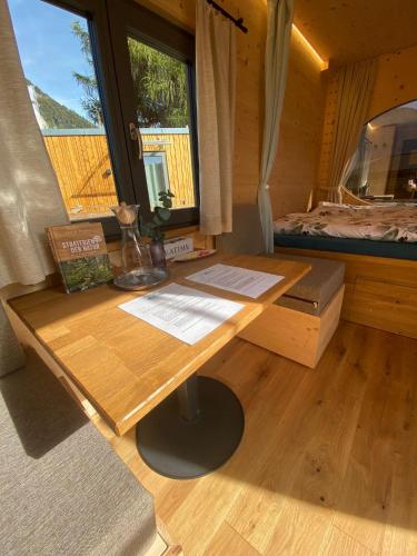 a wooden desk in a room with a bed at Unique Tiny Eco Lodges with gorgeous views to Jungfrau Massiv in Interlaken