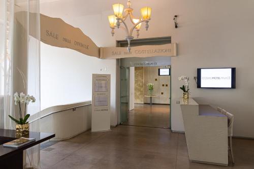 a lobby with a sign that reads save the library at Cosmo Hotel Palace in Cinisello Balsamo