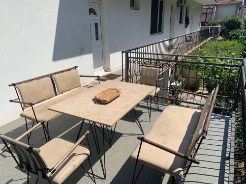a wooden table and chairs on a balcony at Alex Apartments in Budva