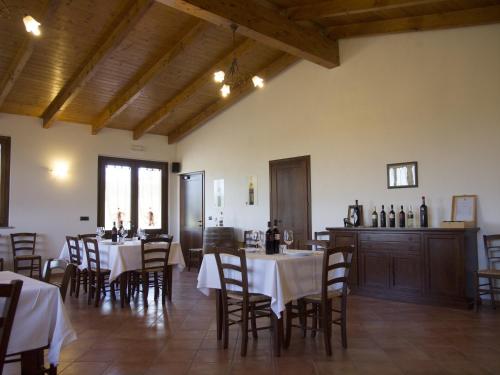 a restaurant with tables and chairs in a room at B&B La Gibiana in Costigliole dʼAsti