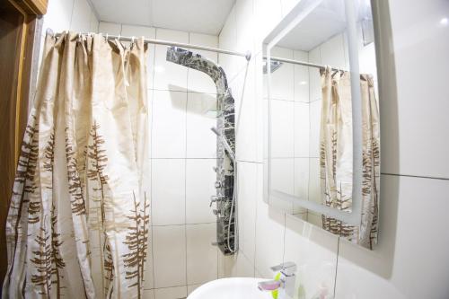 a bathroom with a shower curtain and a sink at Home away from Home. in Galadima