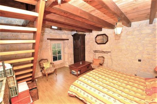 1 dormitorio con 1 cama grande y techo de madera en Calme et bien-être, en Cestayrols