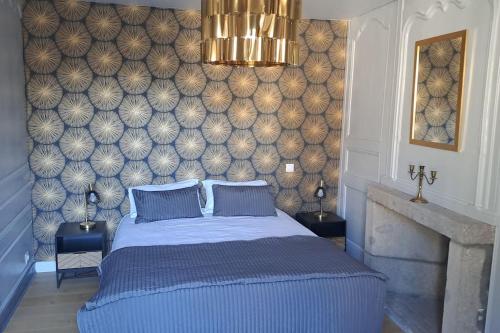 a bedroom with a blue bed and a wall at Chez germaine in Murat