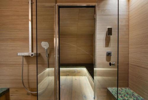 a shower with a glass door in a bathroom at Chalet Les Solans in Les Allues
