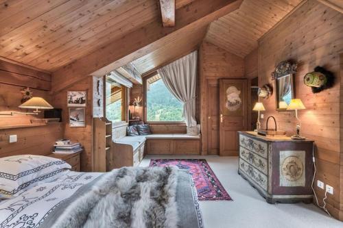 a bedroom with a large bed and a window at Chalet Les Solans in Les Allues
