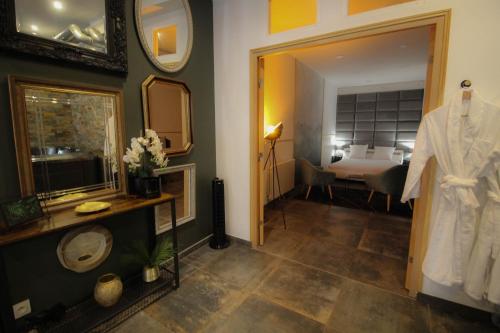 a bathroom with a sink and a mirror and a bedroom at Residence Pasteur Angouleme in Angoulême