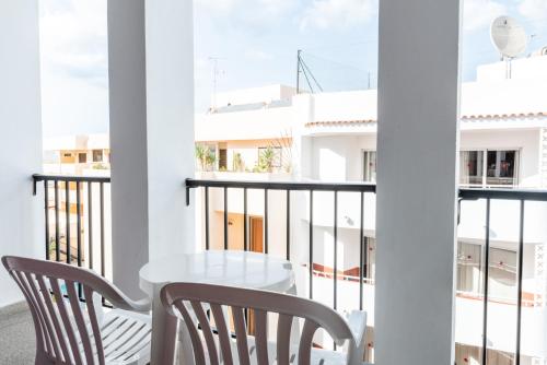 a balcony with a white table and chairs at Ibiza Rocks Hotel - Adults Only in San Antonio